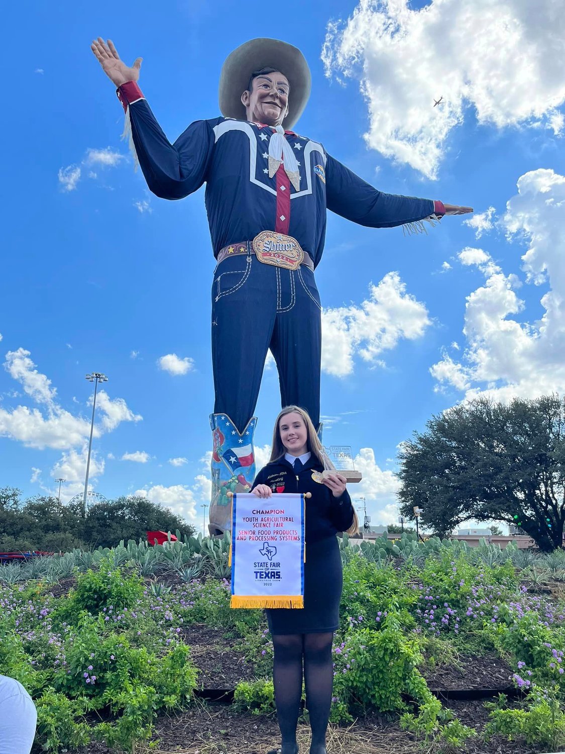 Madailein Fitch, a Taylor High student, poses with Big Tex at the State Fair of Texas in Dallas.